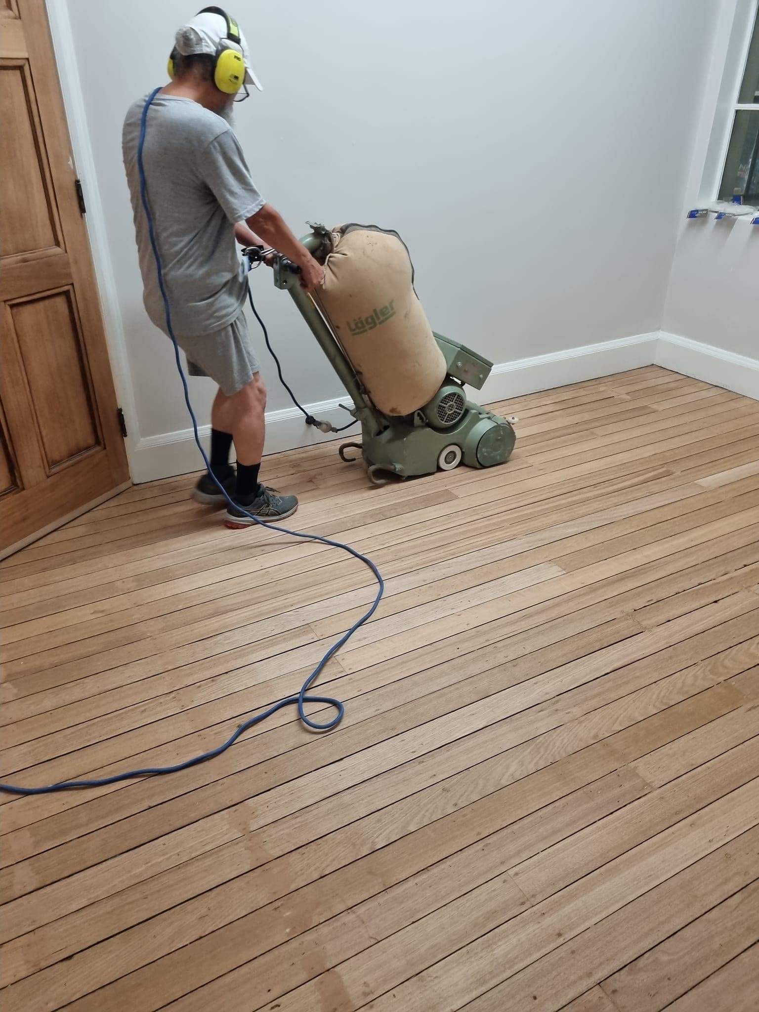 ATA Flooring Sydney tradesman operating a Lagler floor sander on raw timber boards