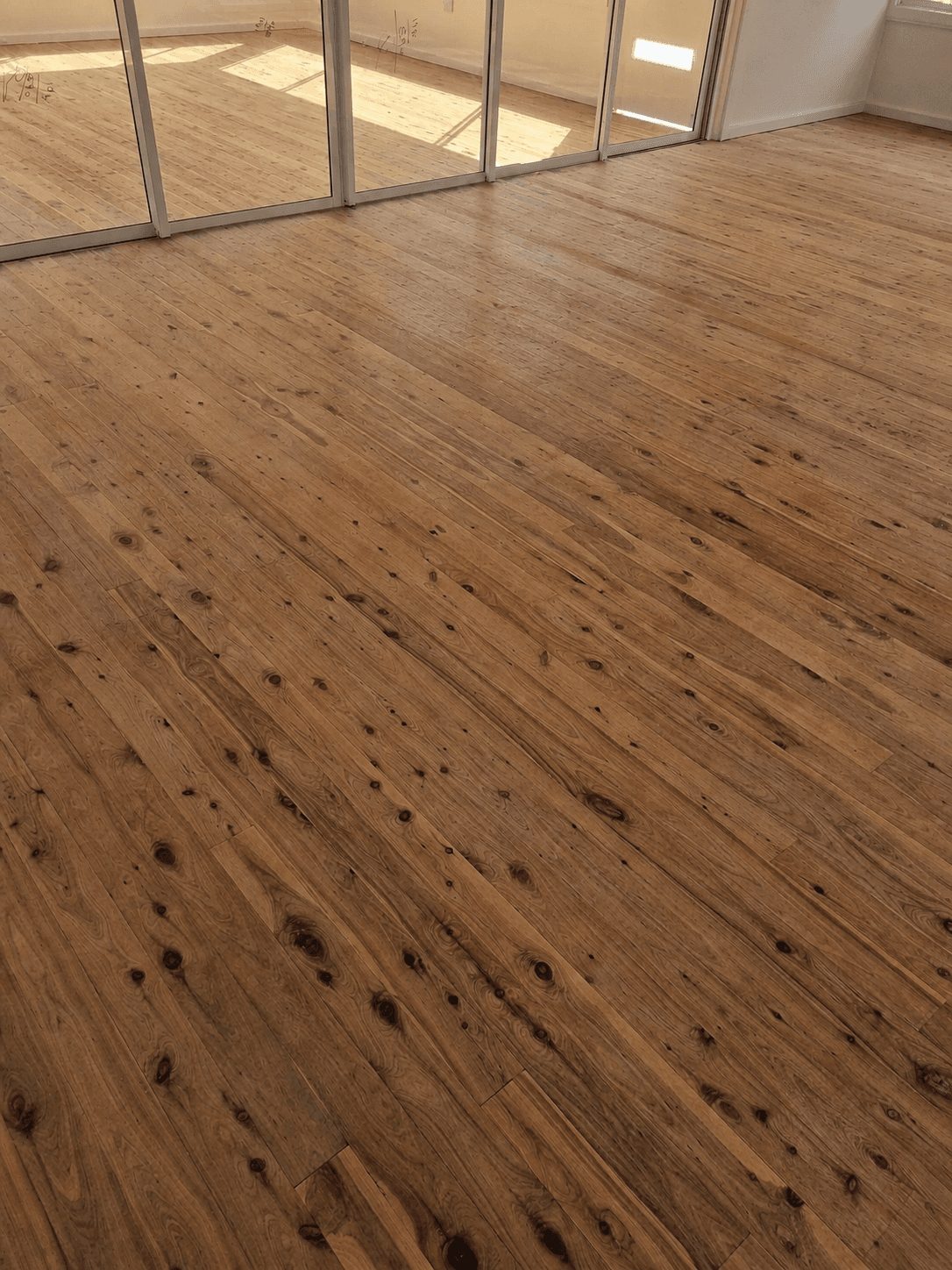 Cypress pine floor in a Sydney home before sanding — raw, unfinished timber