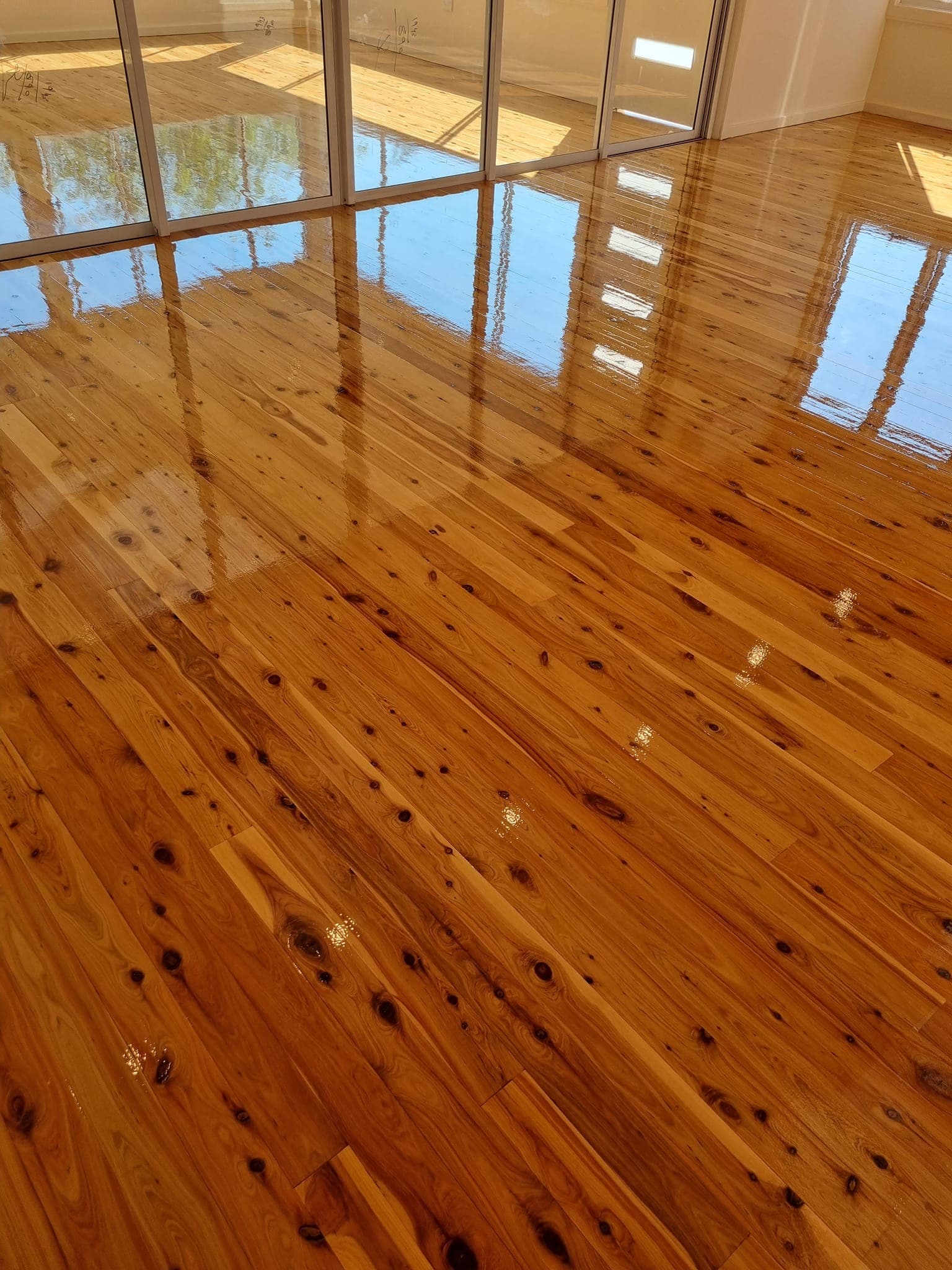 The same Sydney cypress pine floor after sanding and high-gloss polishing by ATA Flooring